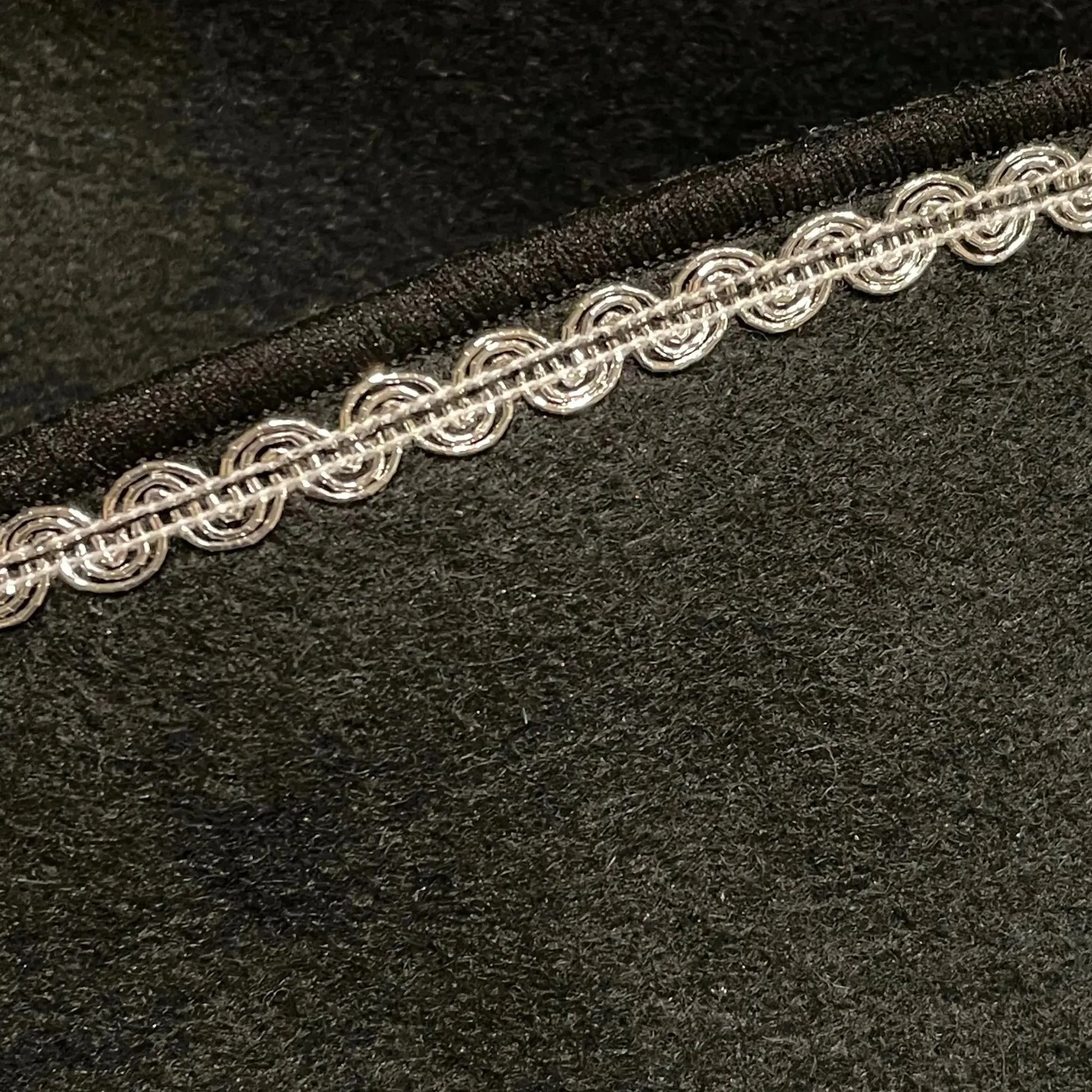 Close-up of decorative trim on felt pirate hat for dress-up play