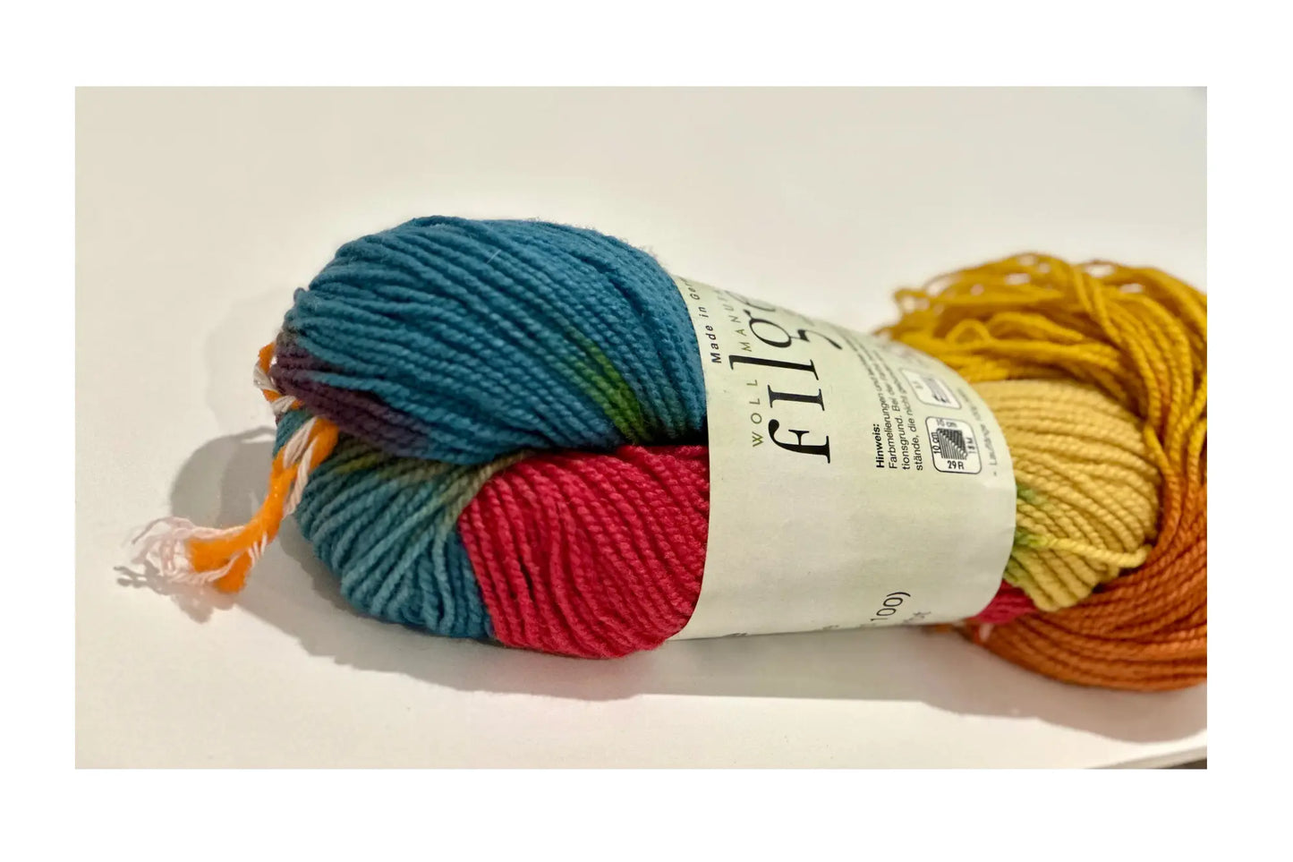 Organic Wool & Silk Plant Dyed Rainbow Yarn close up on a light background