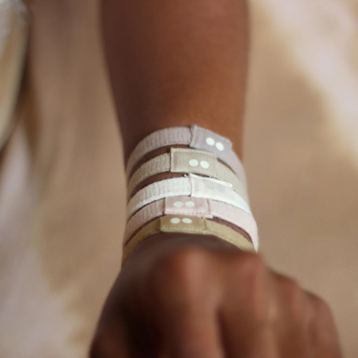 Kooshoo plastic free hair ties as wristlets on someone's arm like bracelets