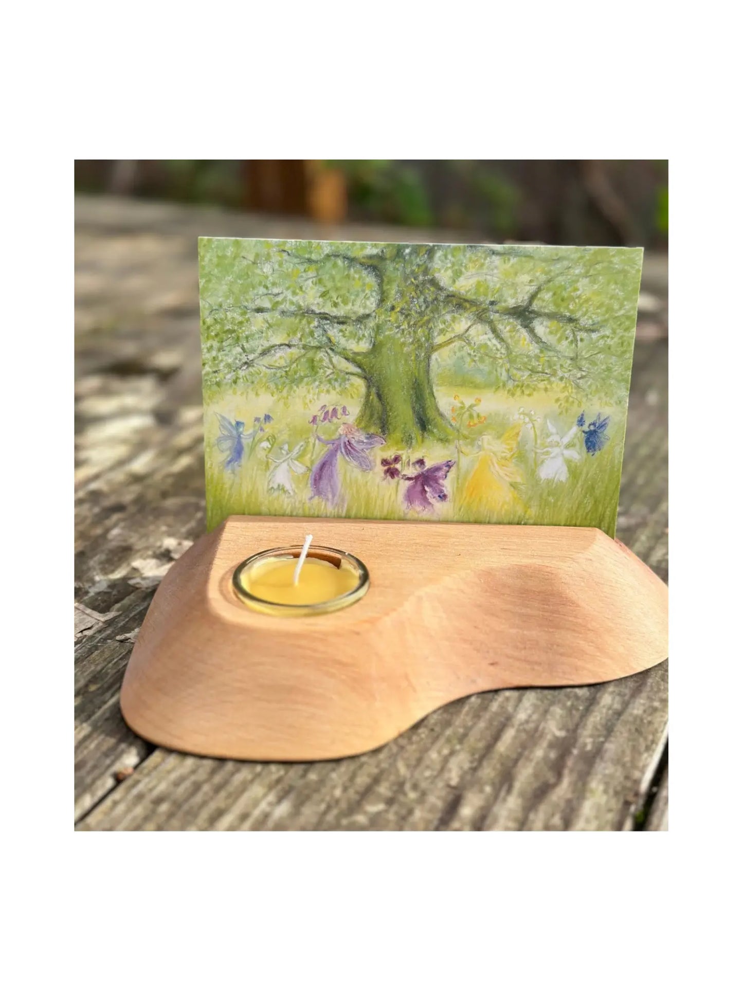 Alderwood Photo and Postcard Holder with Tealight and a postcard of fairies dancing on rustic outdoor wooden table