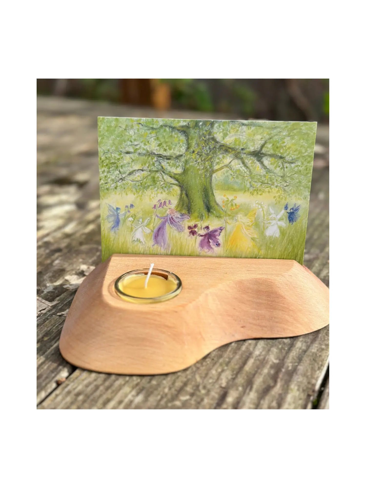 Alderwood Photo and Postcard Holder with Tealight and a postcard of fairies dancing on rustic outdoor wooden table
