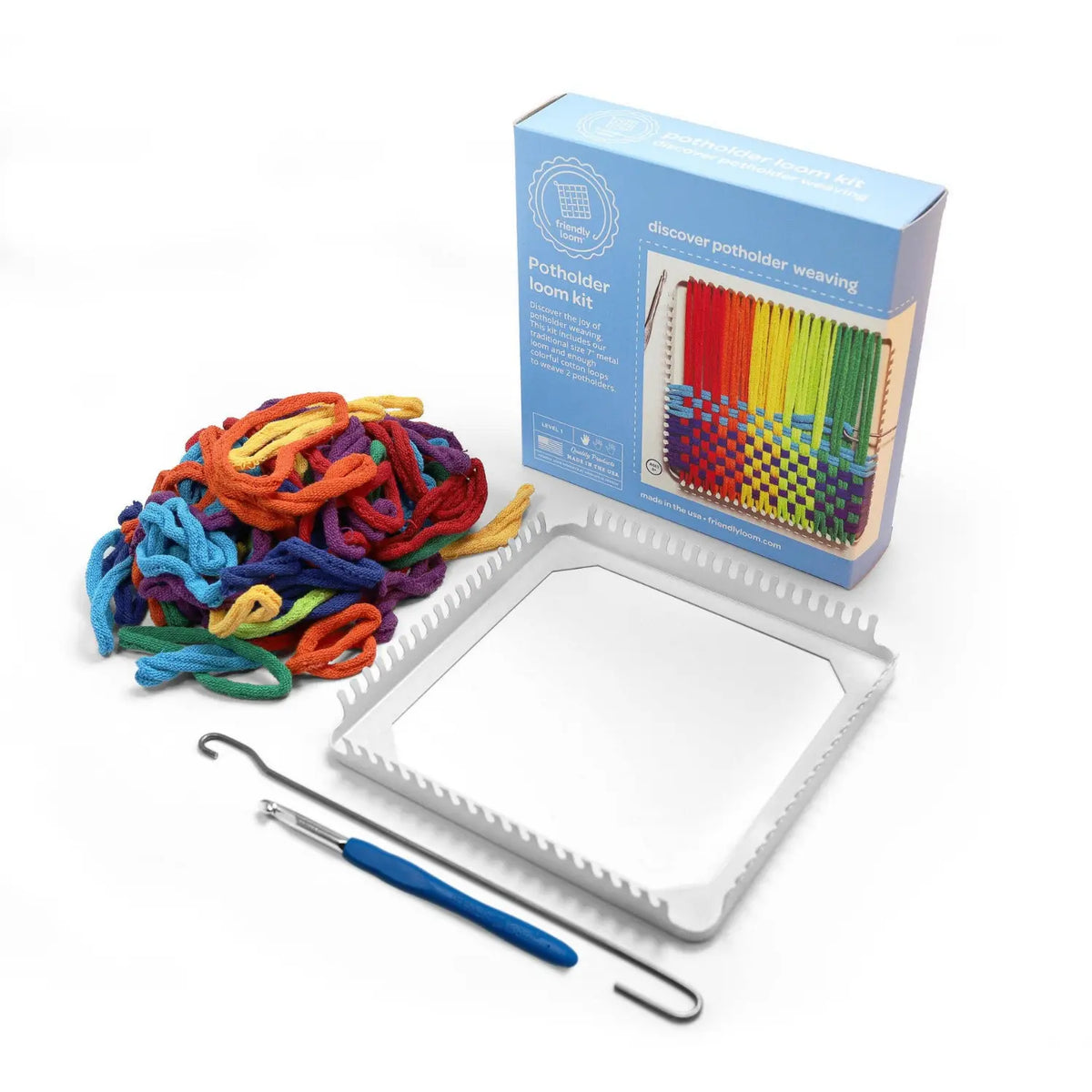 Potholder loom kit contents: 7-inch metal loom, rainbow cotton loops, metal weaving hook and crochet hook beside the box