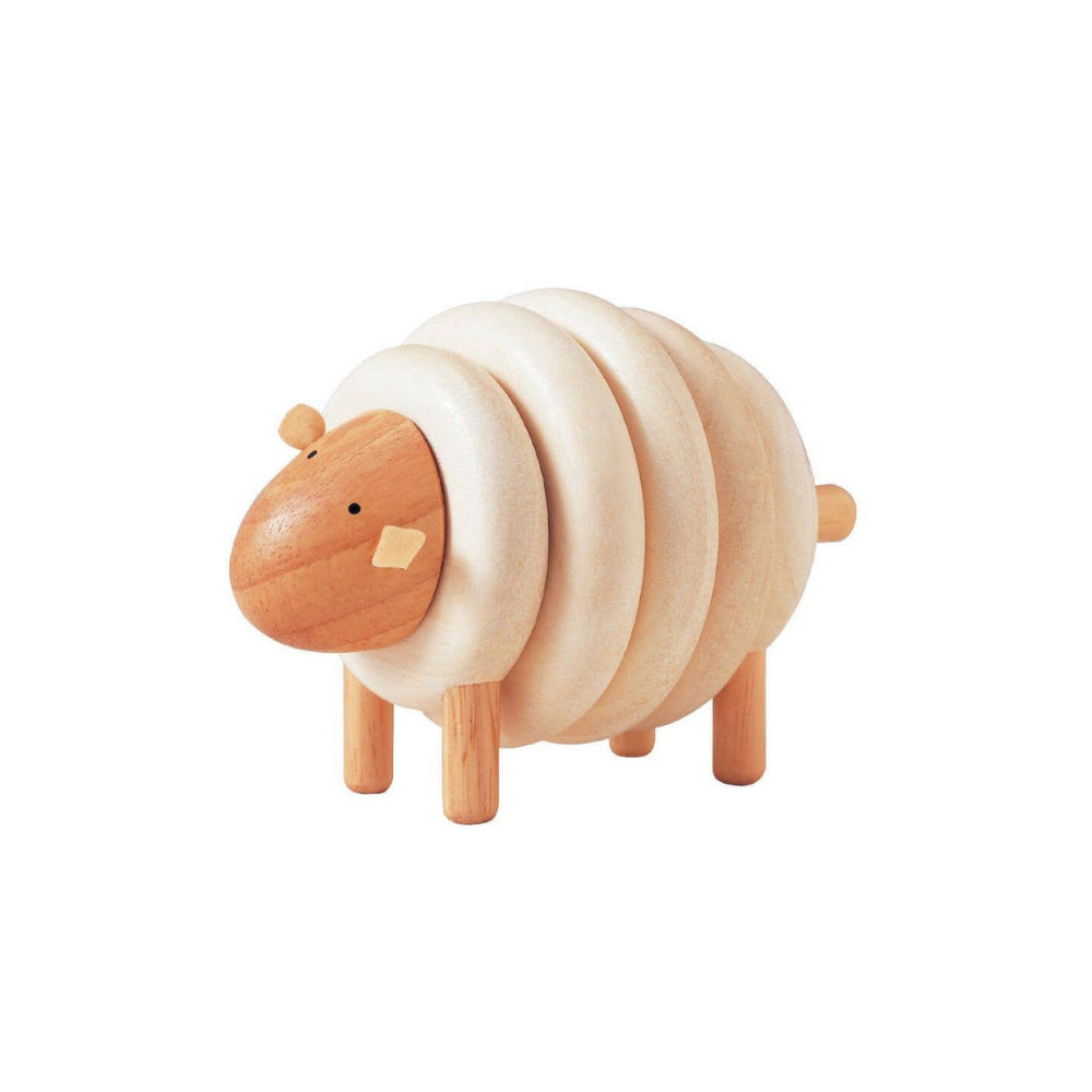 Wooden sheep toy on a white background