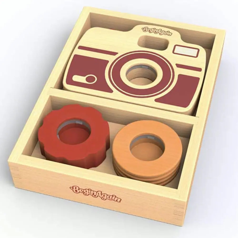 Wooden toy camera set with circular shapes in a 'Begin Again' branded box.