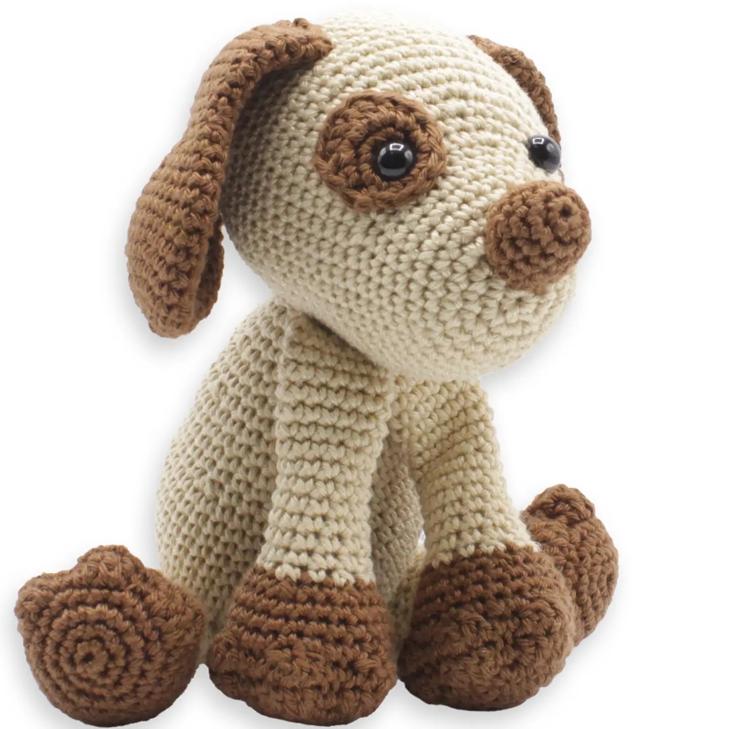 Finished puppy stuffed animal made from a crochet kit on white background