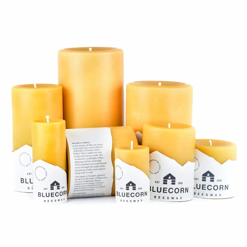 Collection of beeswax candles with Bluecorn Bee蜡 packaging on a white background