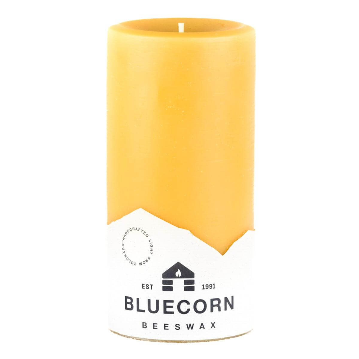 Yellow beeswax candle with Bluecorn Beeswax logo on a white background