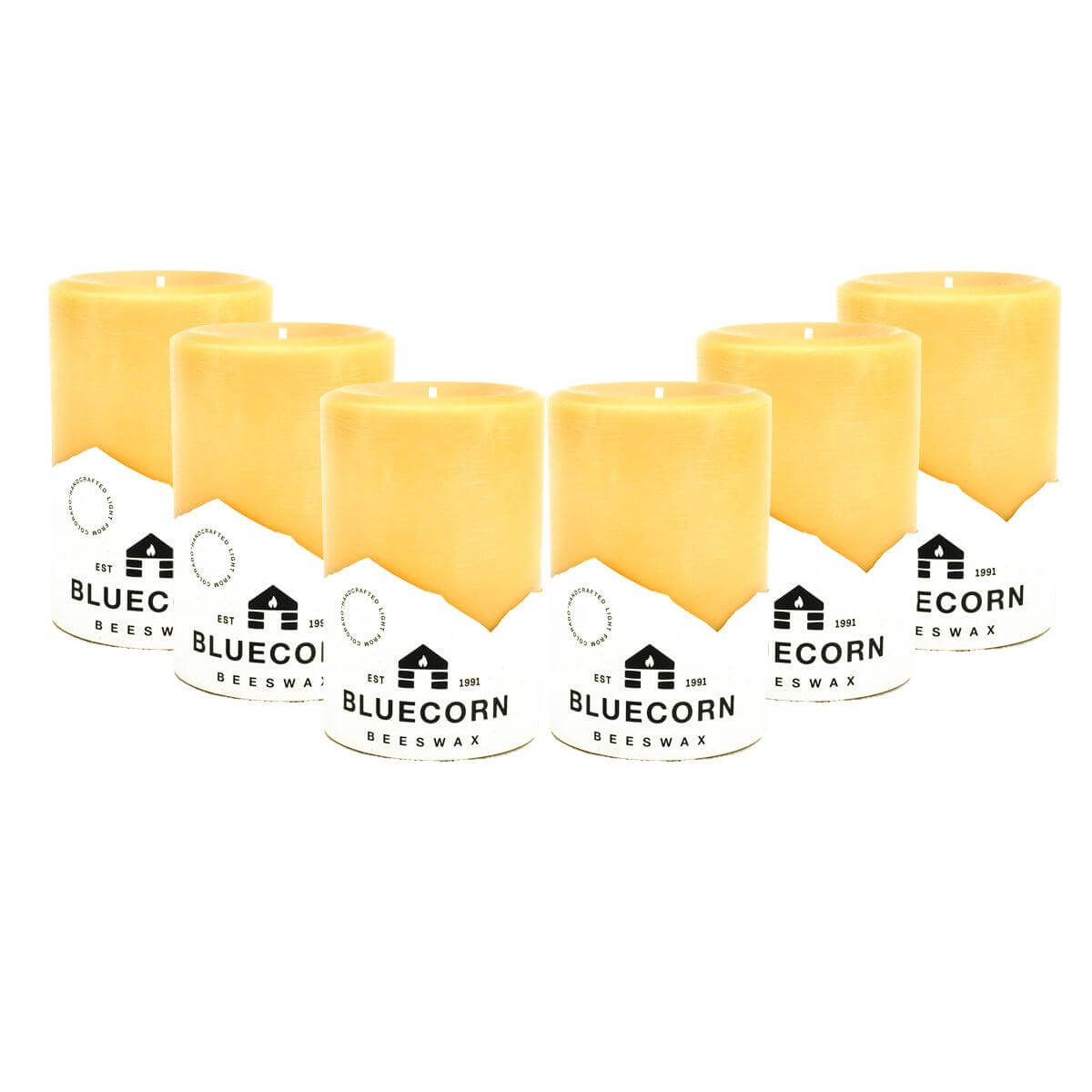 Set of six yellow beeswax candles with 'Bluecorn Beeswax' labels on a white background