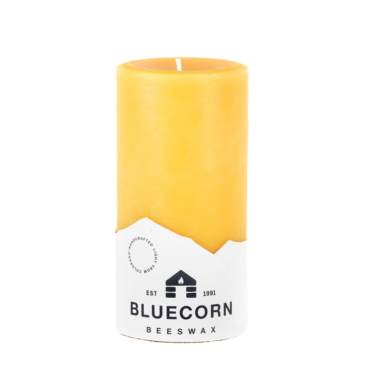 Yellow beeswax candle with a Bluecorn Beeswax label on a white background