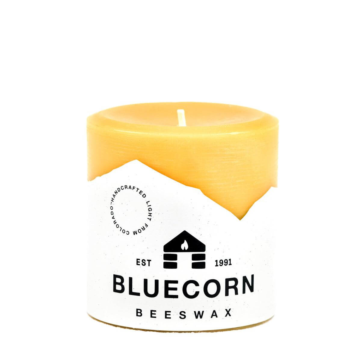 Yellow beeswax candle with Bluecorn Beeswax logo on a white background