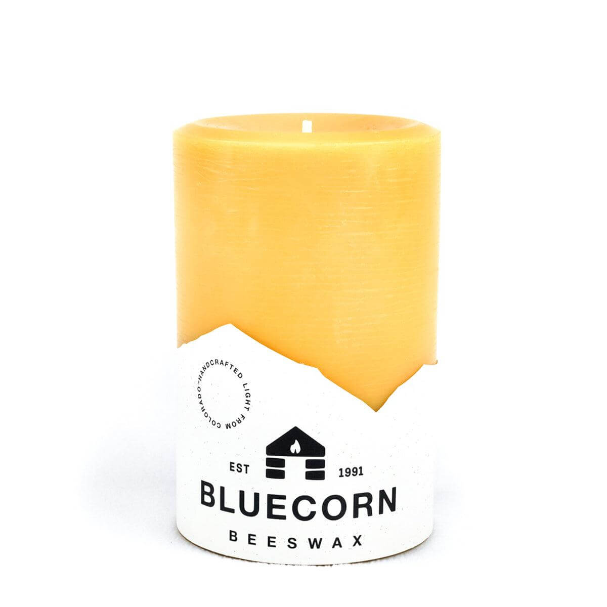 Beeswax candle with Bluecorn Beeswax branding on a white background