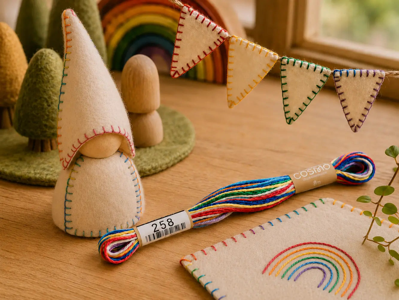 Handmade gnome with rainbow embroidery floss and banner