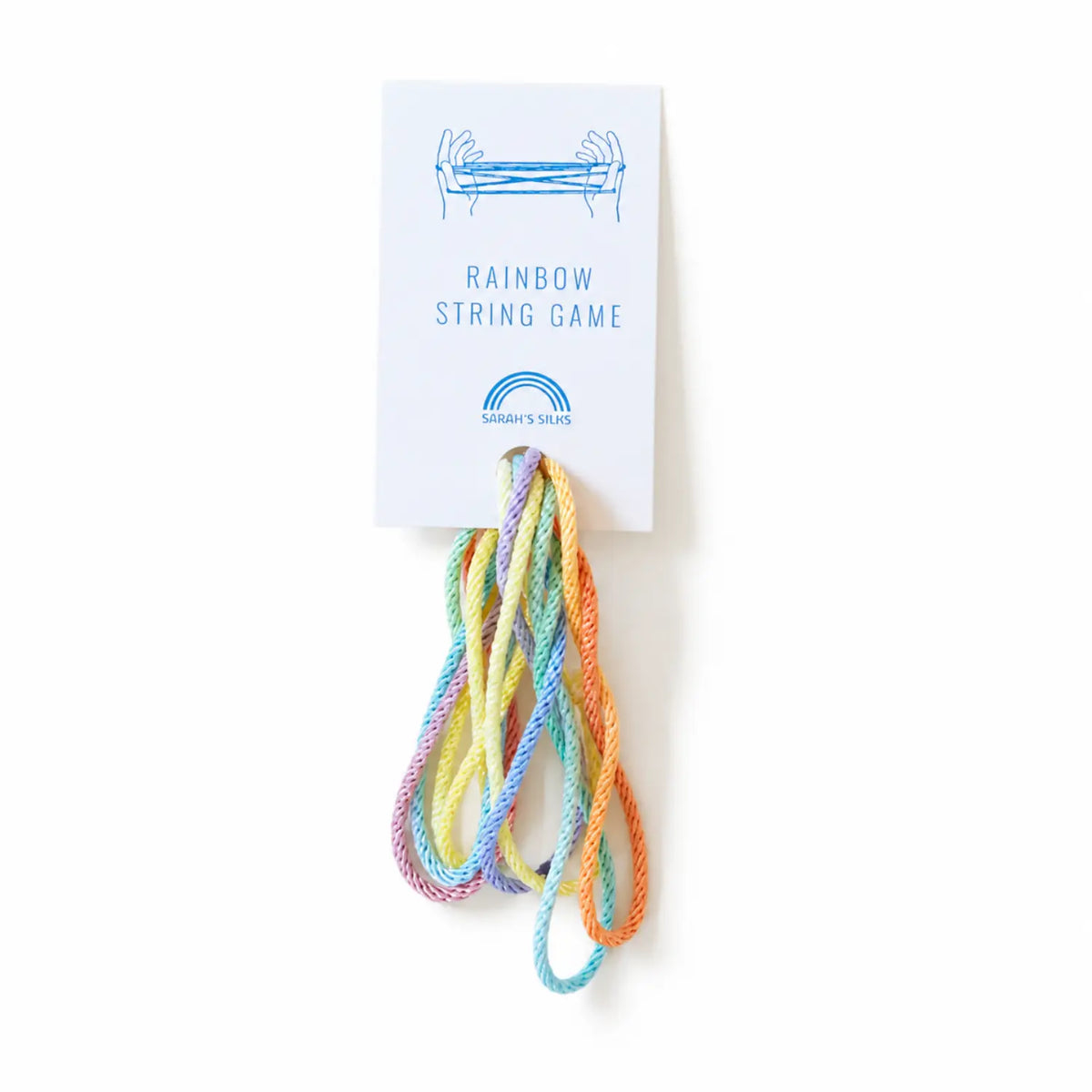 Sarah’s Silks rainbow string game with pastel cord on a white background