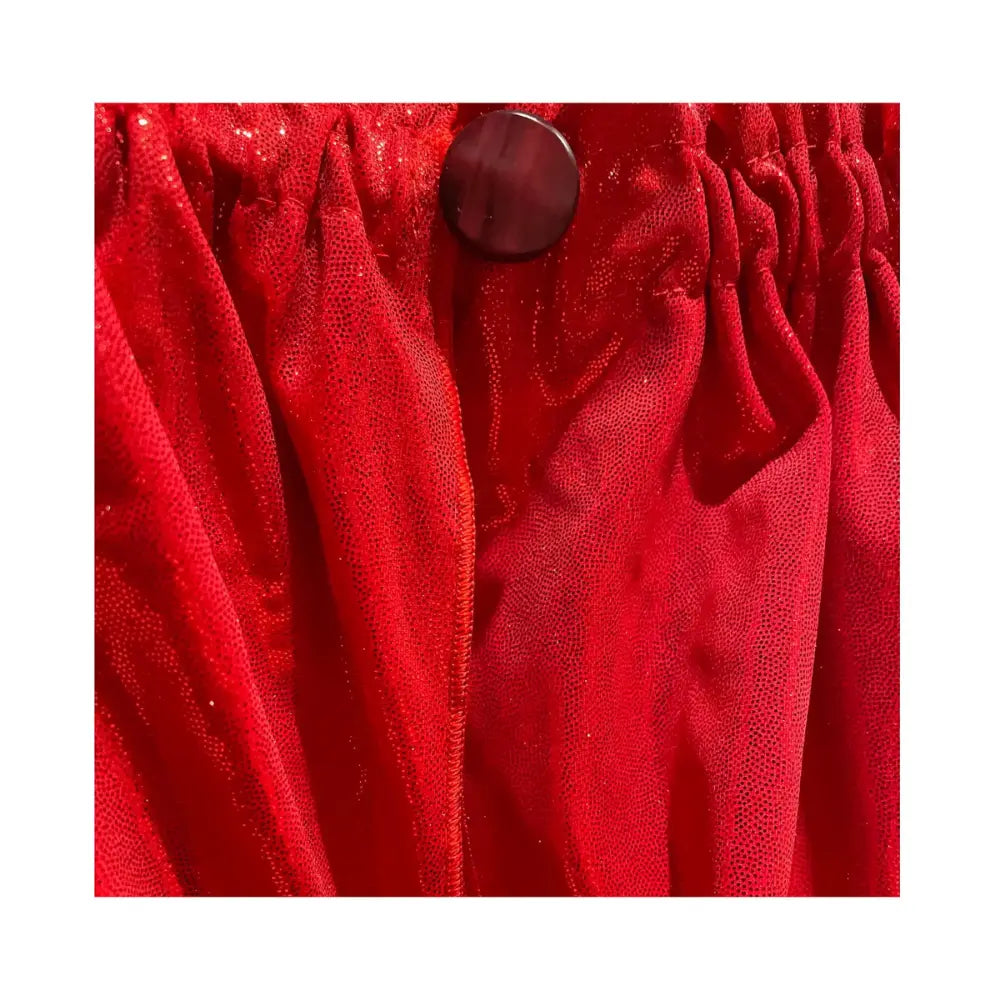 Close-up of jeweled button closure on red shimmer cape for kids