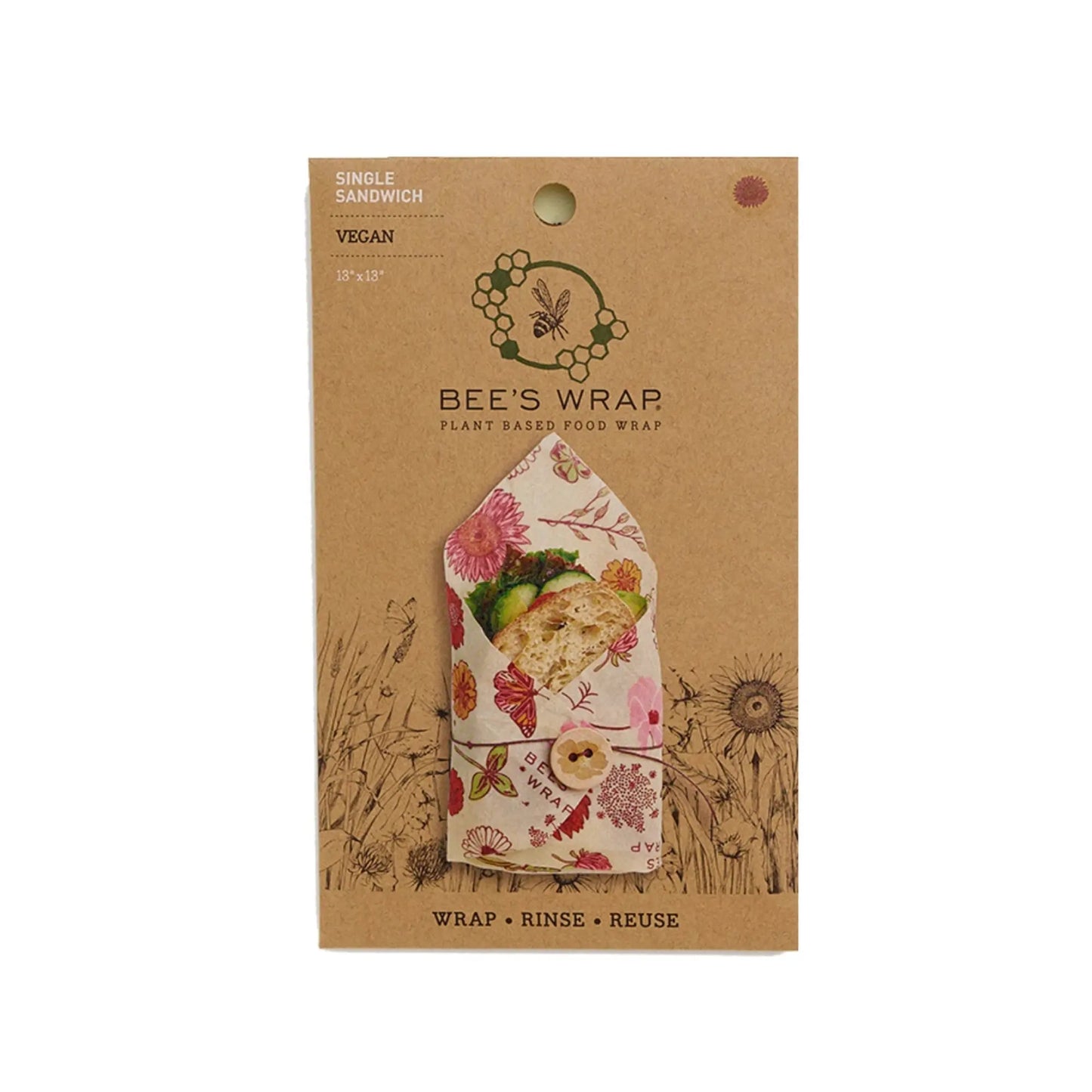Bee's Wrap packaging with a sandwich wrapped in it on a white background