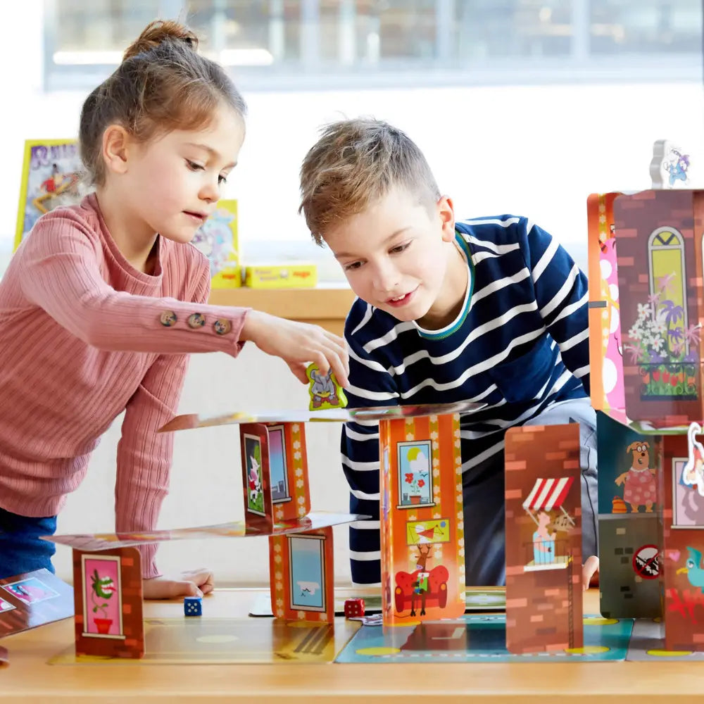 Children building tall card tower in Rhino Hero Super Battle game