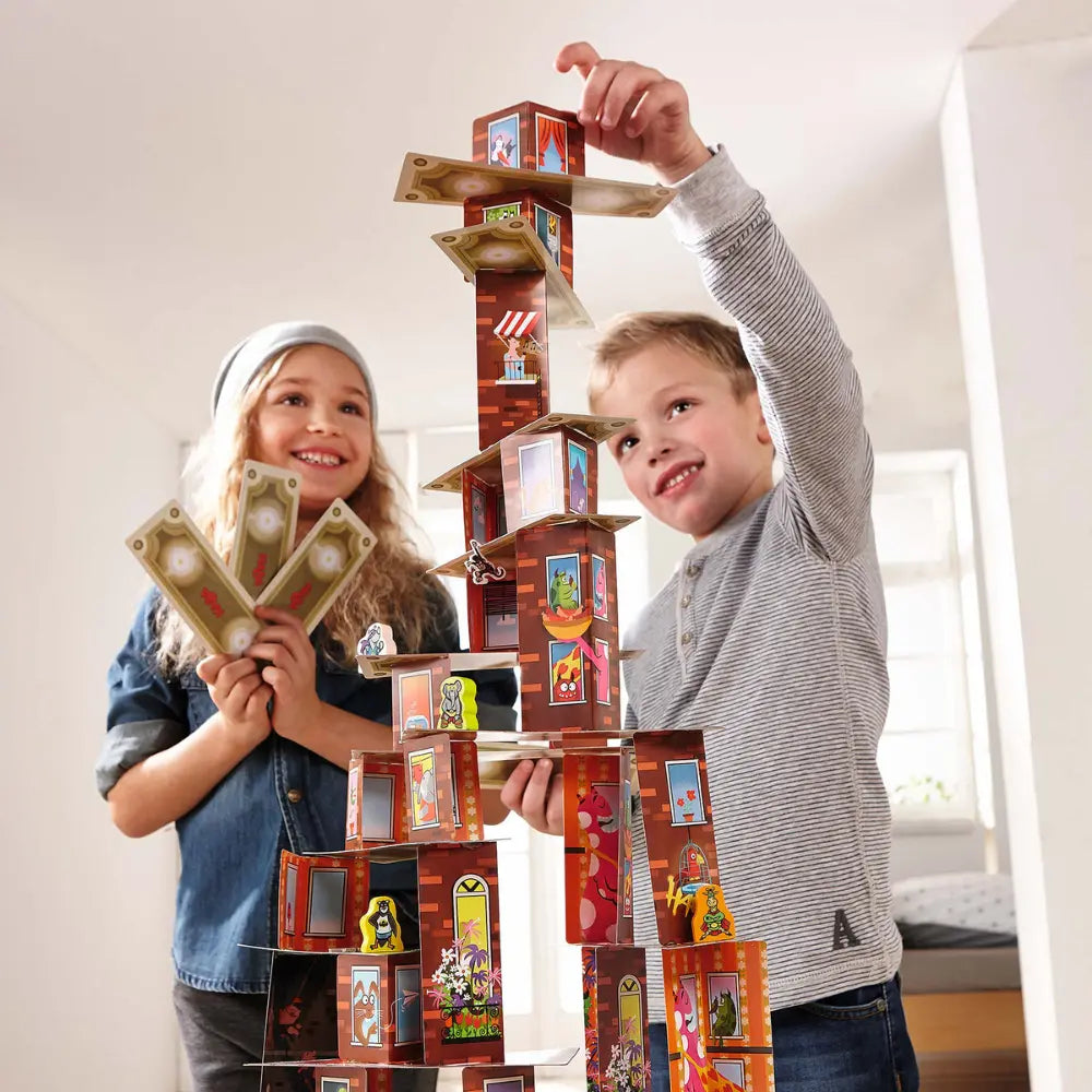 Children building tall card tower in Rhino Hero Super Battle game