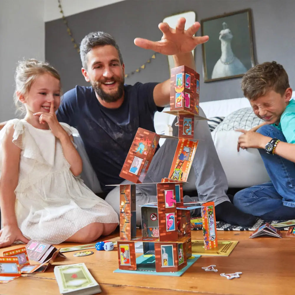 Parent and children building card tower in Rhino Hero Super Battle game