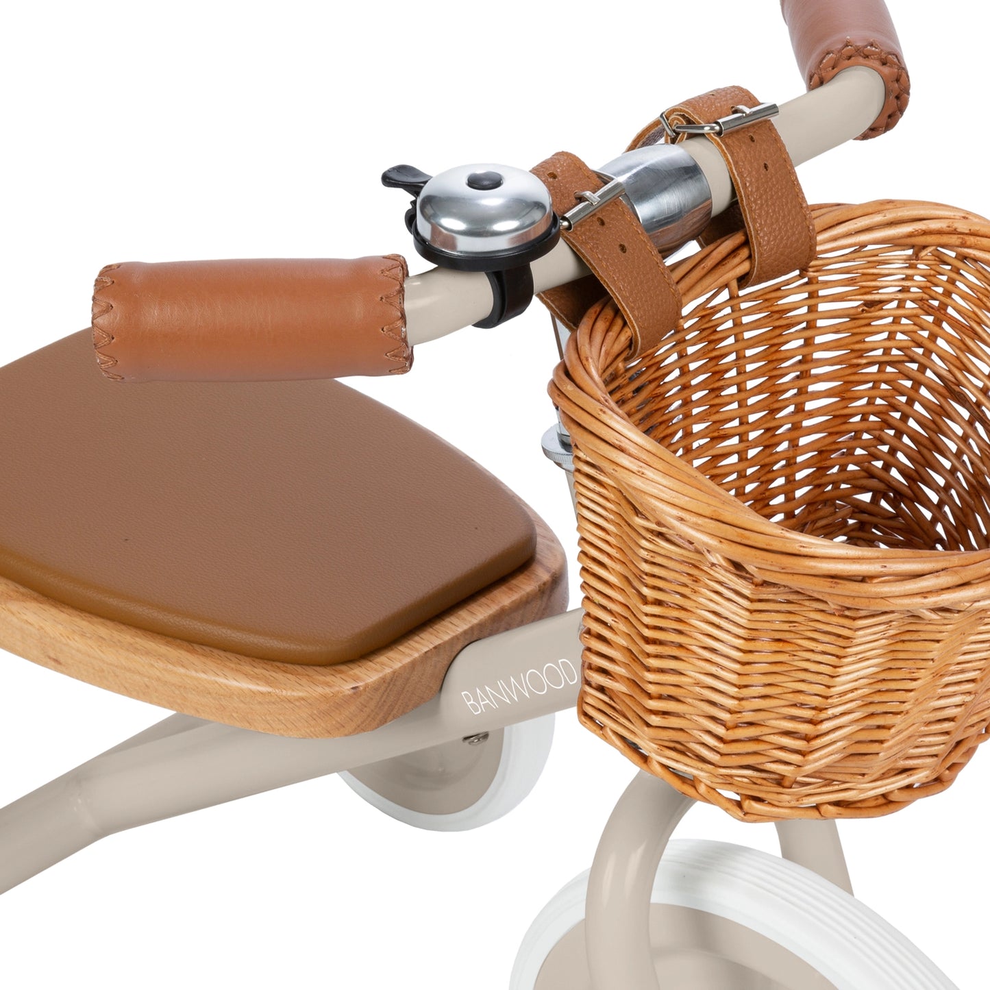 Children's tricycle with brown seat and wicker basket on a white background