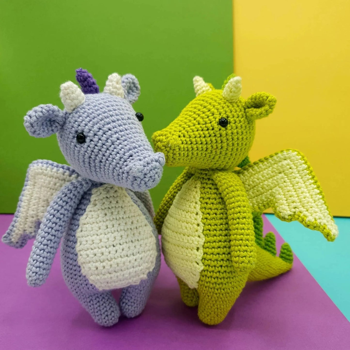 Green and lilac handmade crochet dragons showing color options