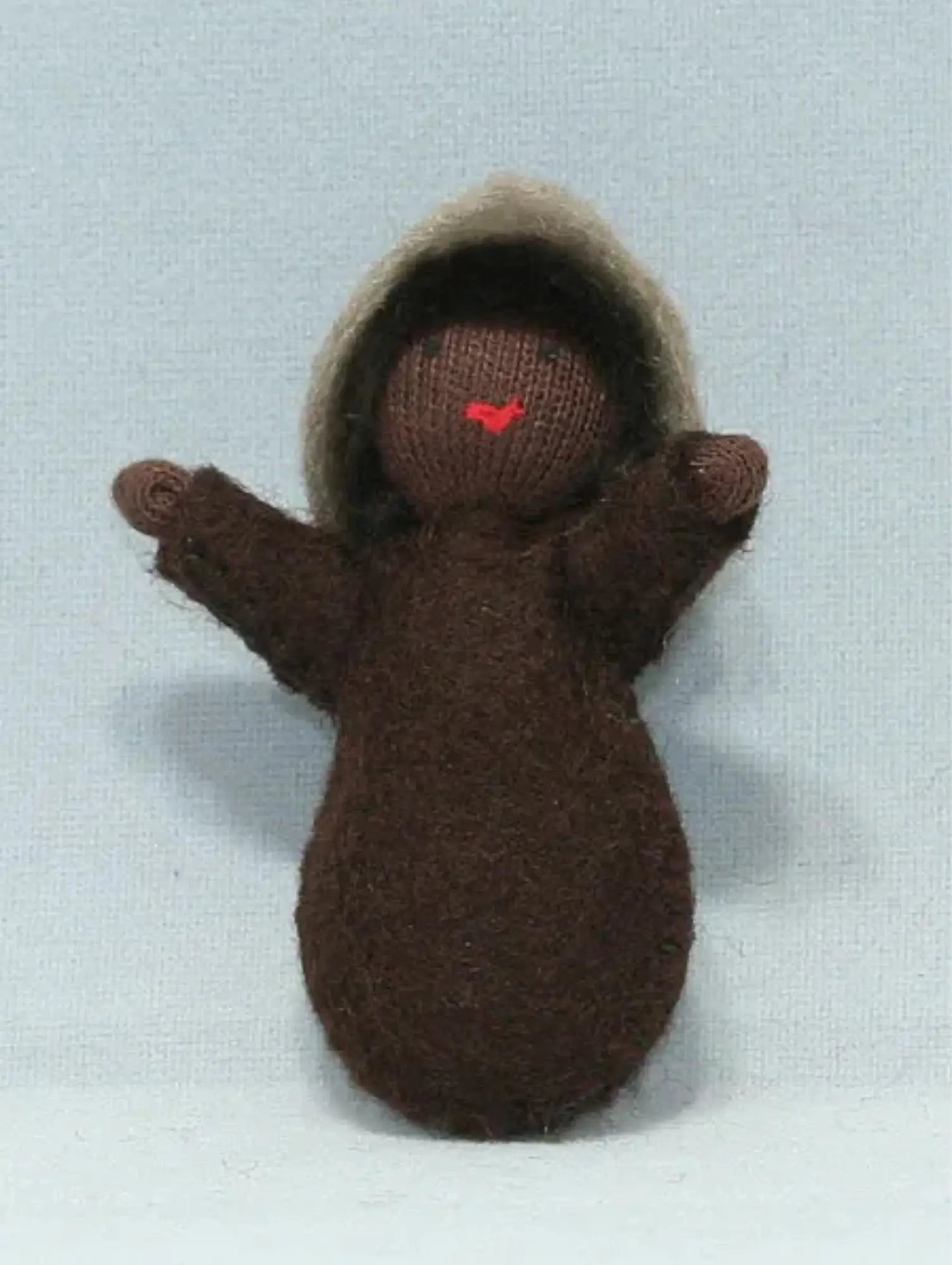 A seed baby ambrosia doll with dark skin tone for nature tables on a white background