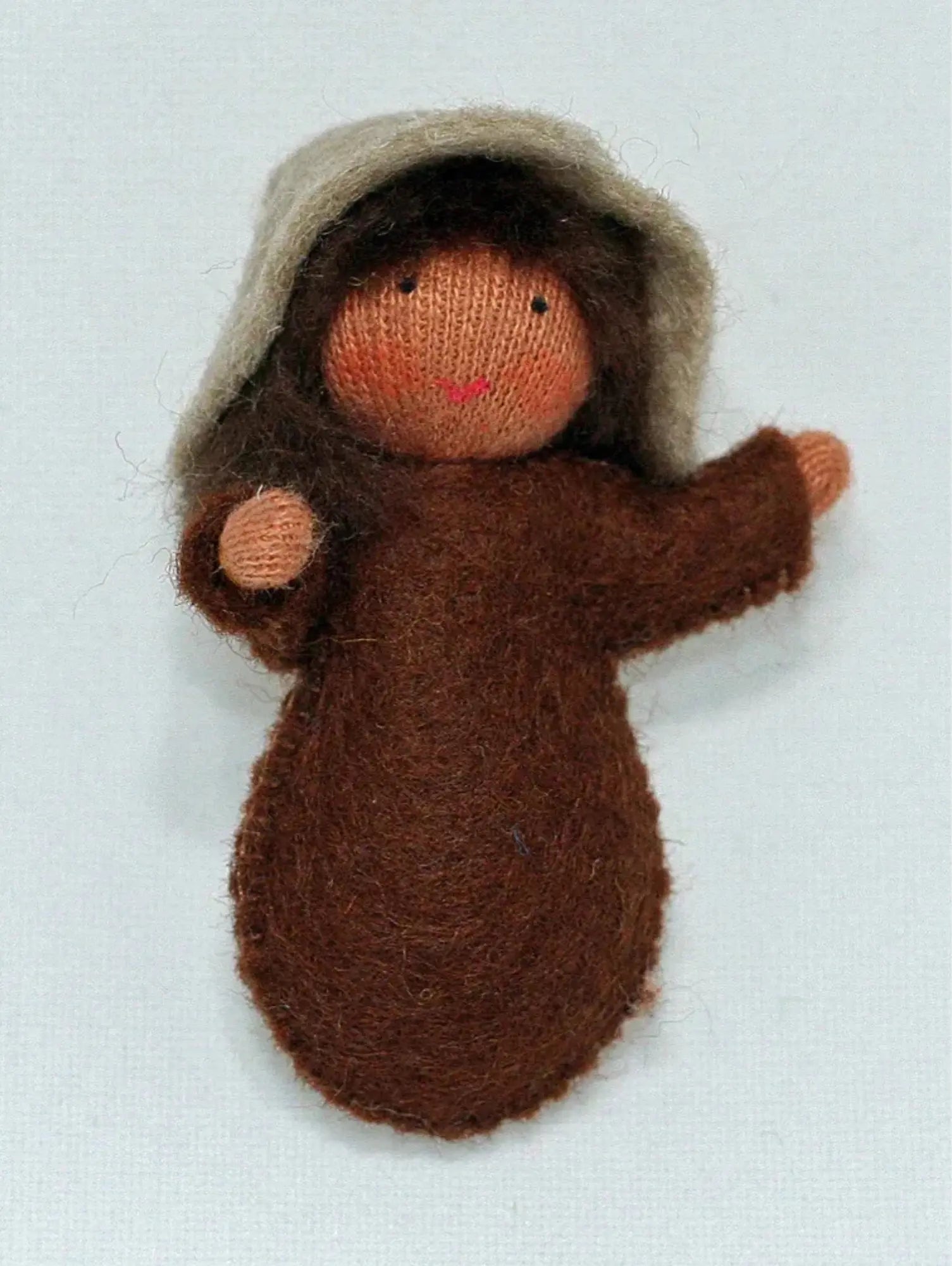 A seed baby with medium skin tone ambrosia doll for nature tables on a white background