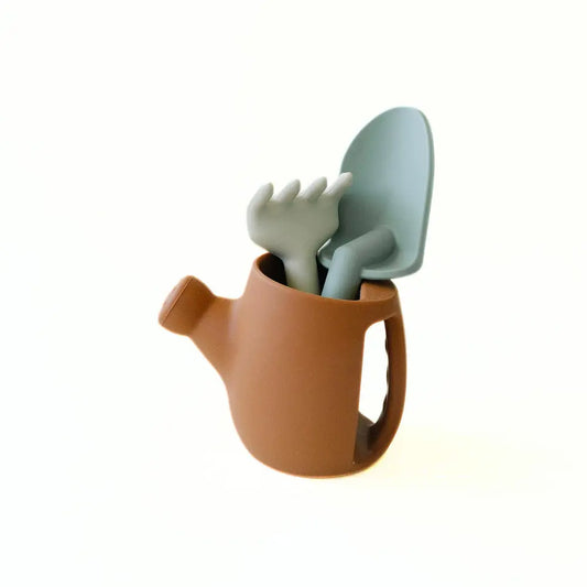 Set of gardening tools including a trowel, spade, and watering can on a white background