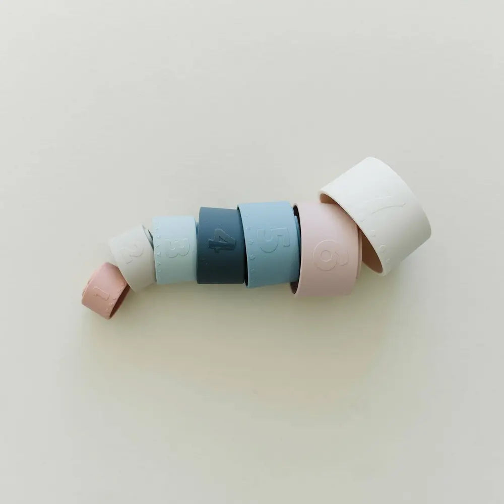 Silicone stacking cups nested on their side on light background