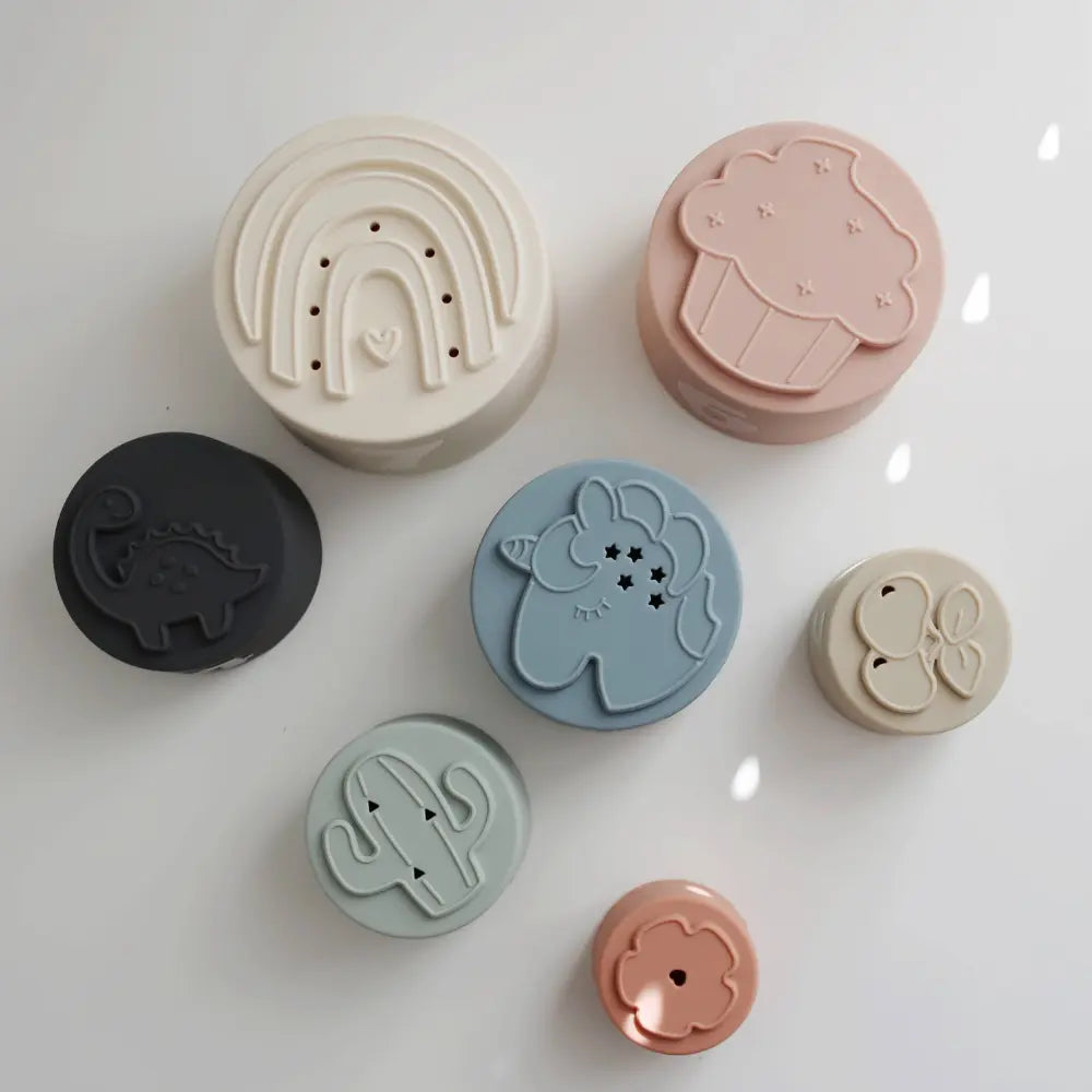 Set of colorful silicone mold shapes bottoms on a white background