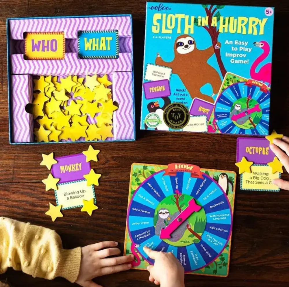 Overhead view of Sloth in a Hurry with cards, spinner, tokens, and game box arranged for play.