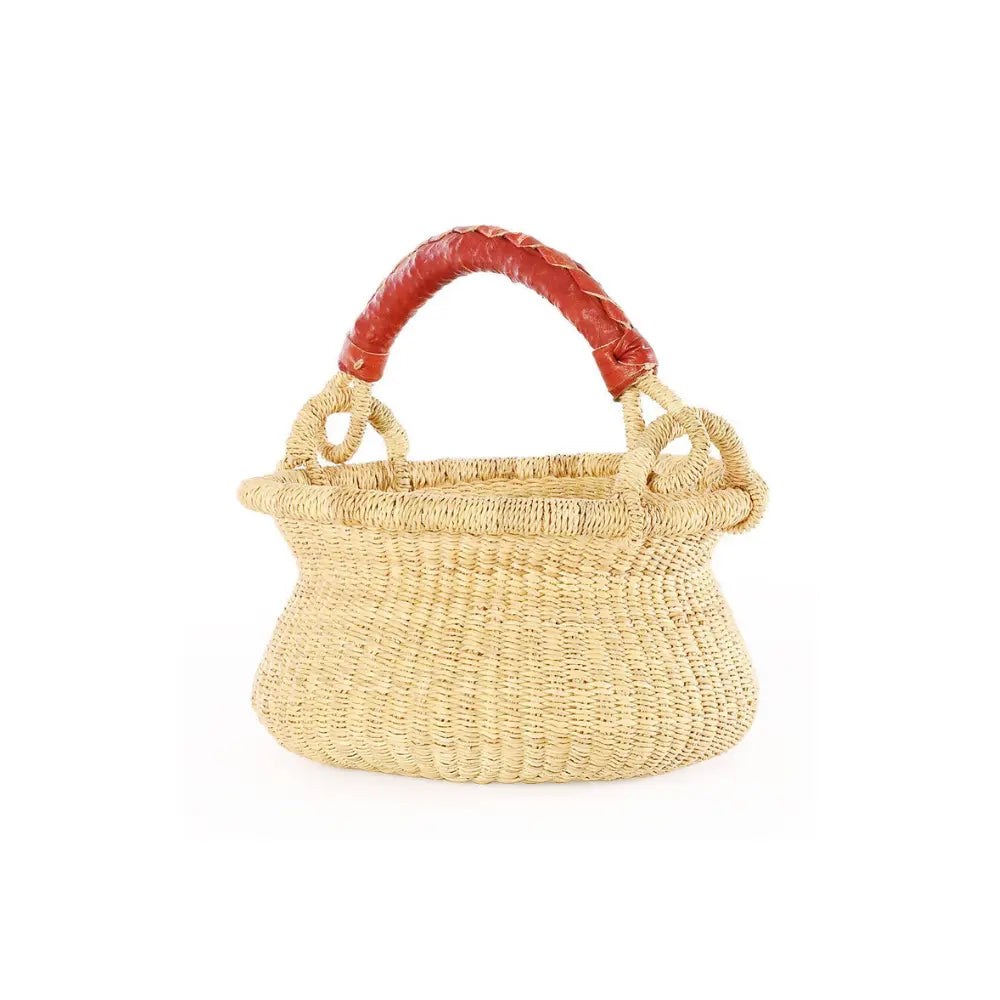 Woven elephant grass baby bolga swing basket with red handle on a white background