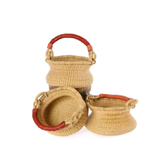 Small handwoven grass basket with swing handle shown from multiple angles including interior view and handle positions