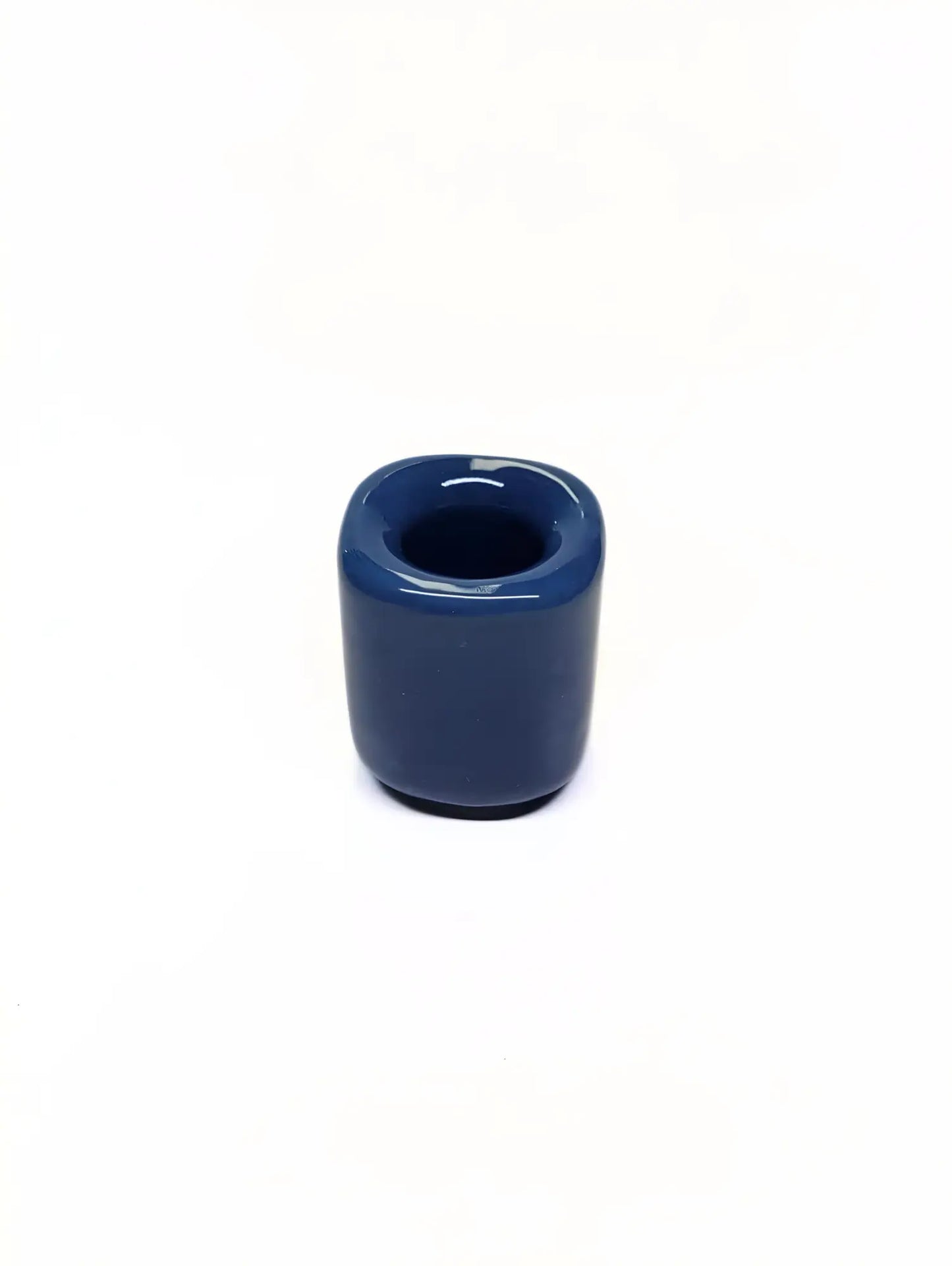 Blue ceramic taper candle holder on a white background
