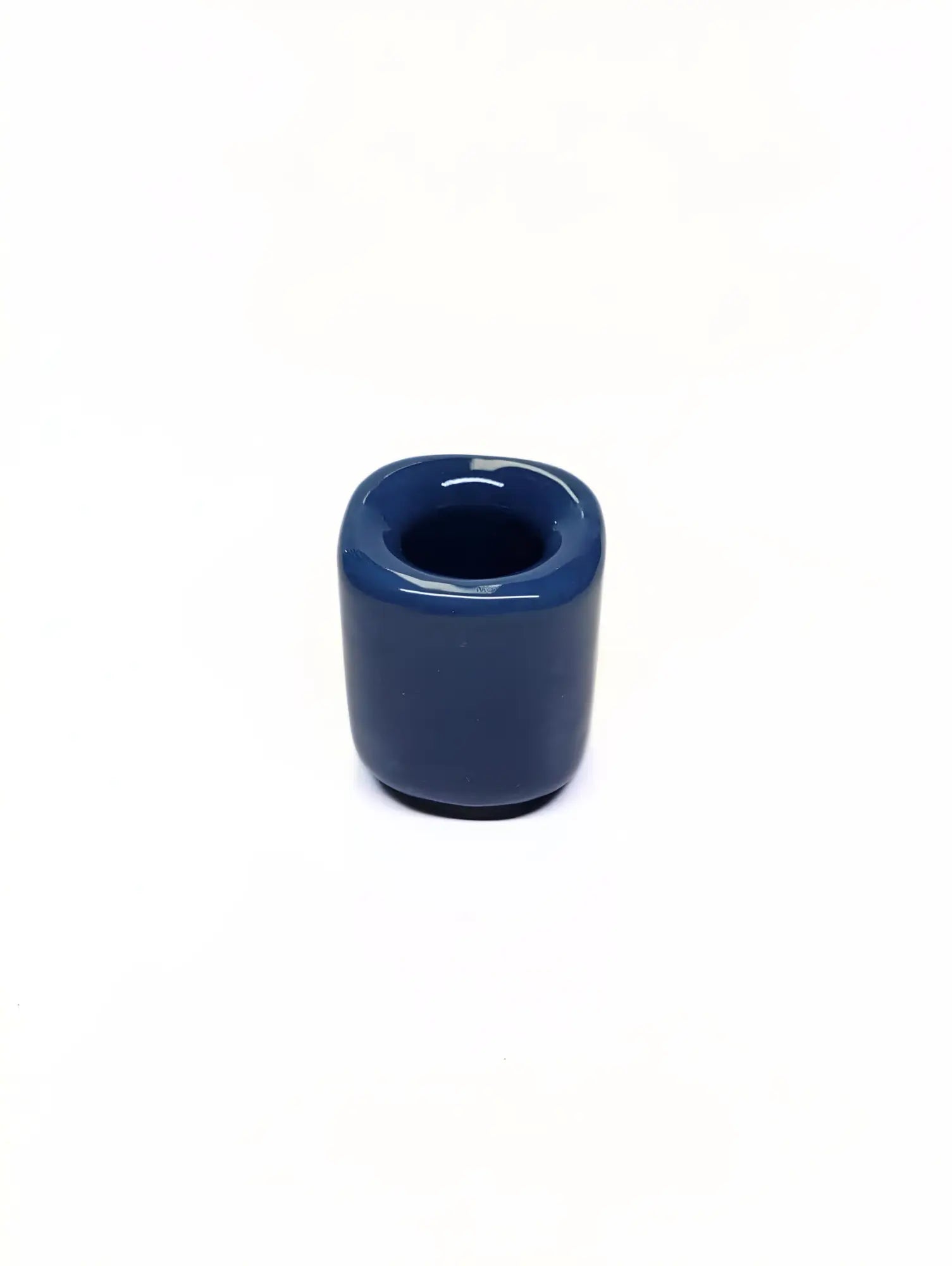 Blue ceramic taper candle holder on a white background