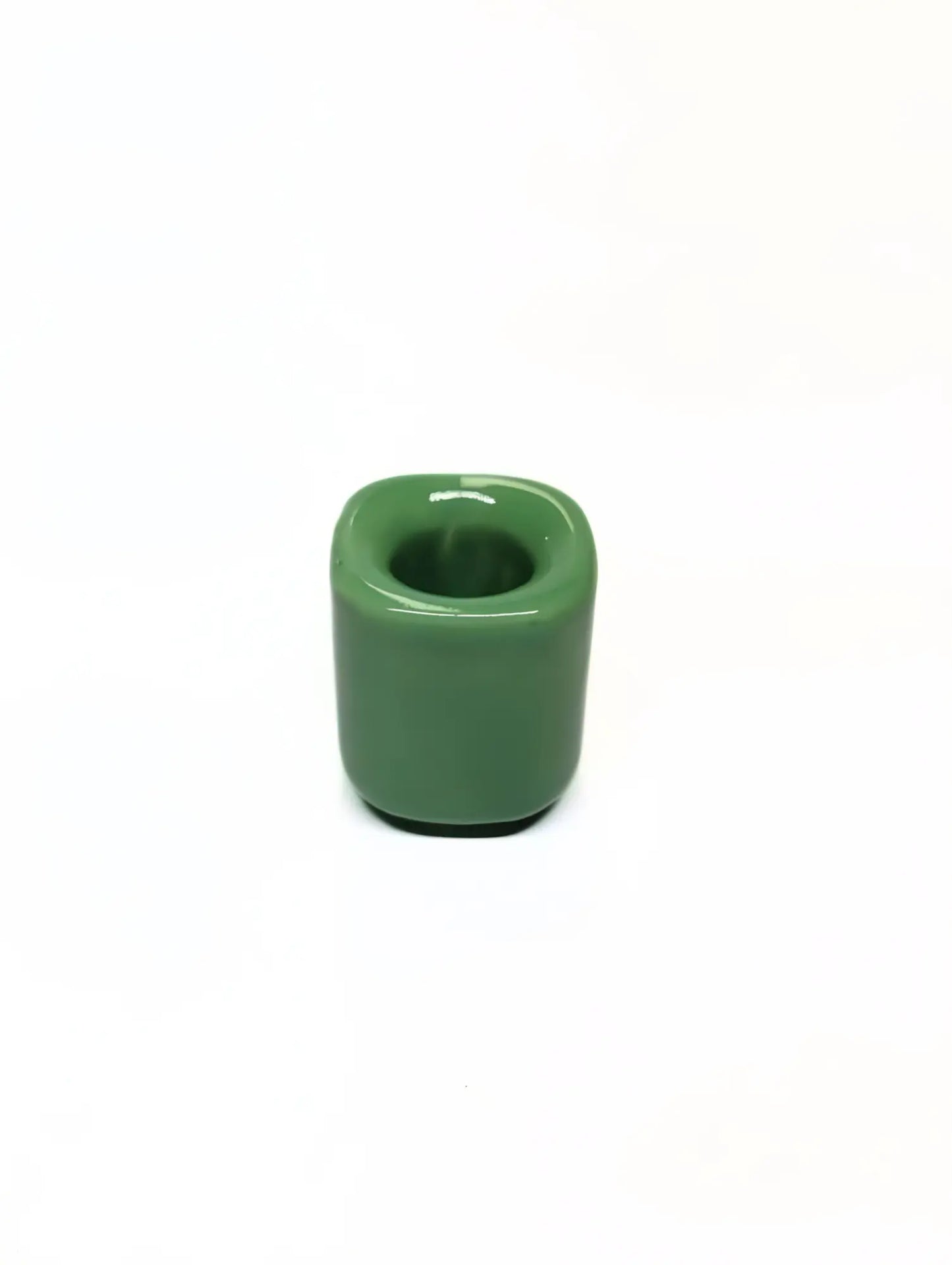 Light green ceramic taper candle holder on a white background