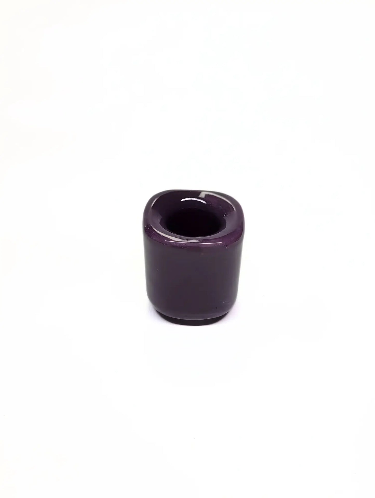 Purple ceramic taper candle holder on a white background