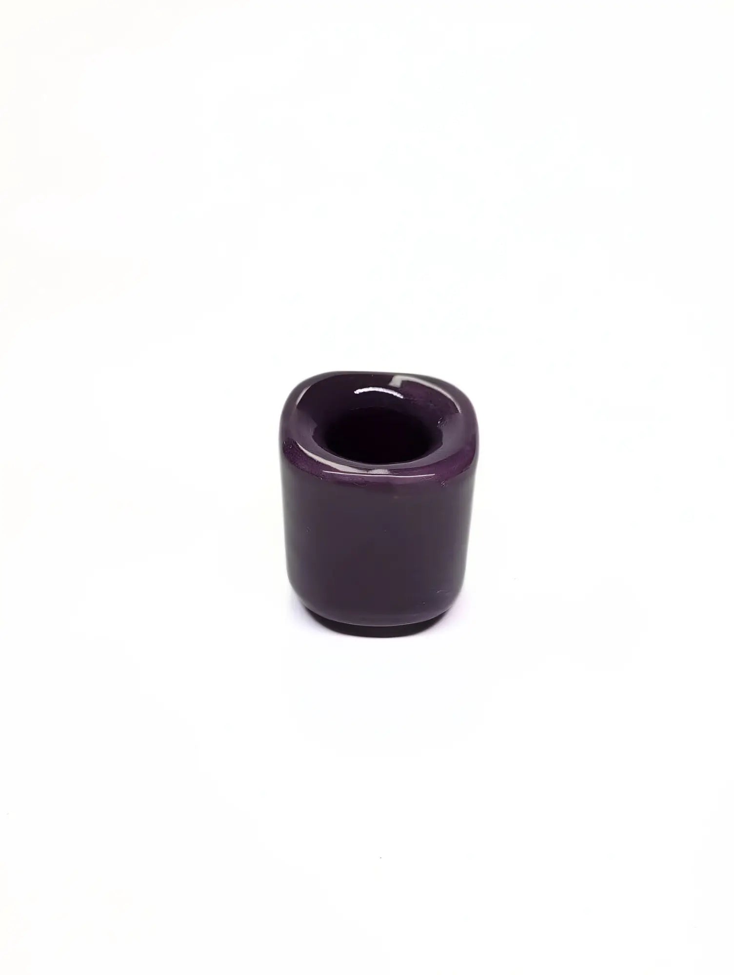 Purple ceramic taper candle holder on a white background