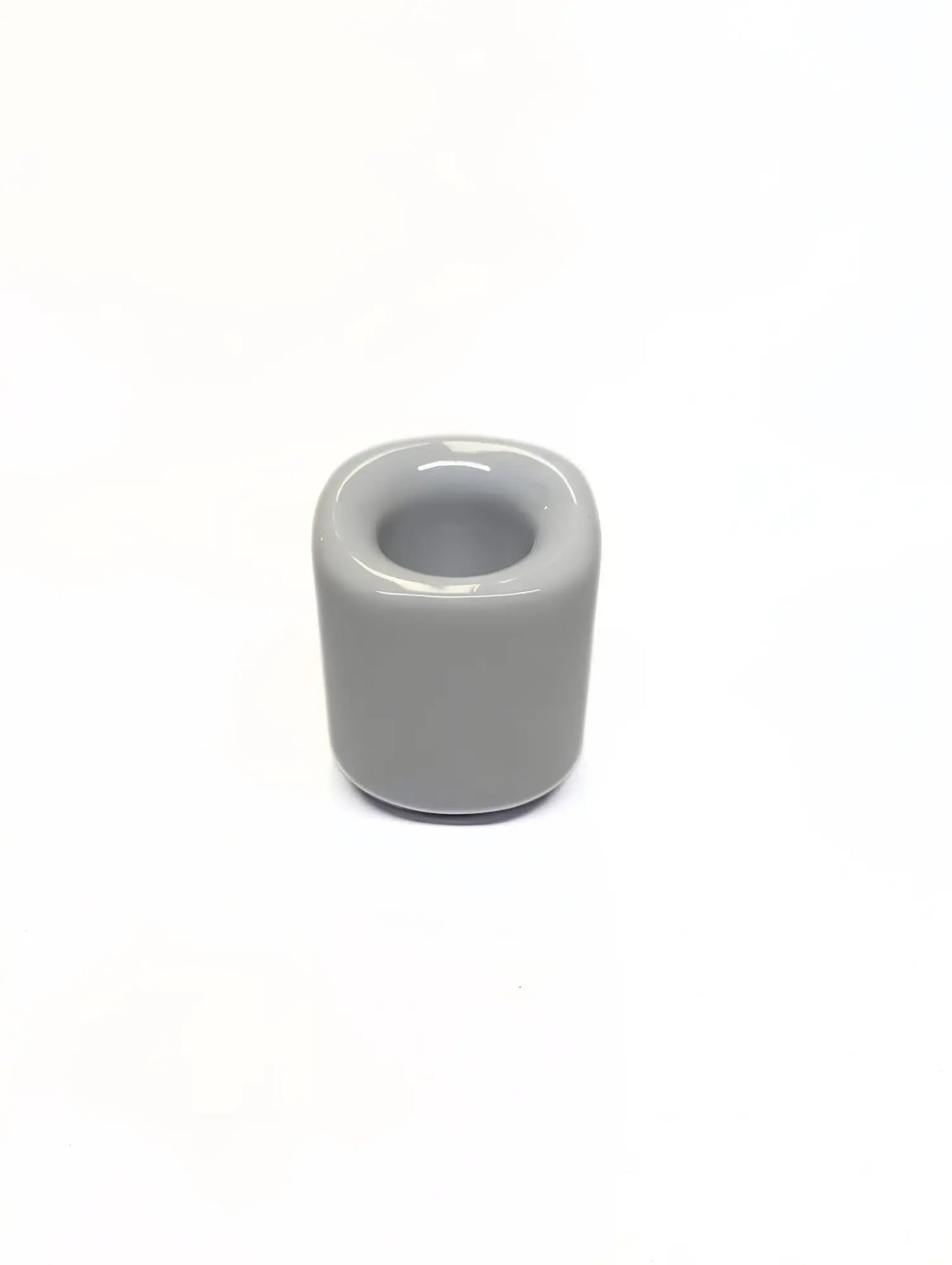 White ceramic taper candle holder on a white background