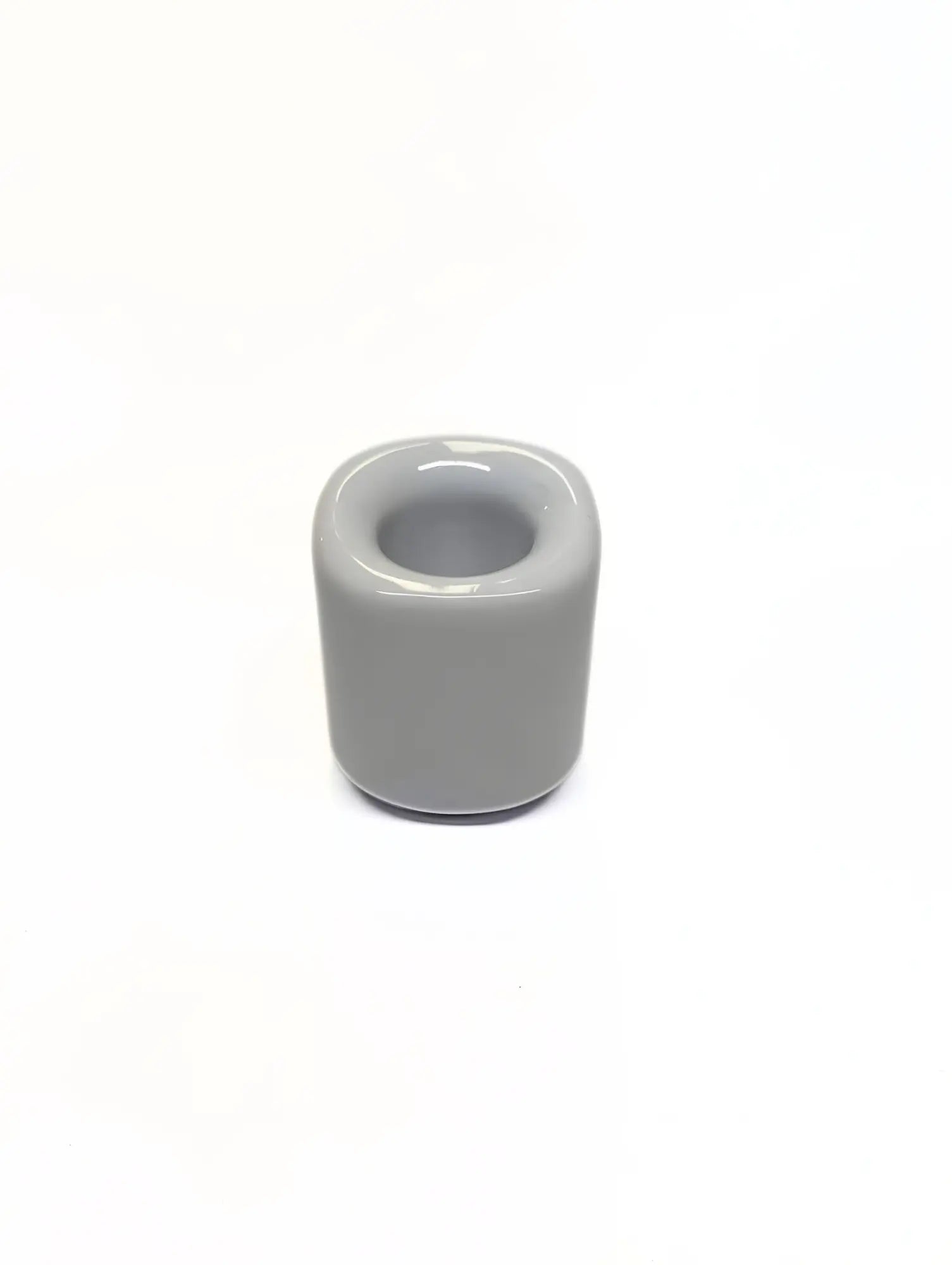 White ceramic taper candle holder on a white background