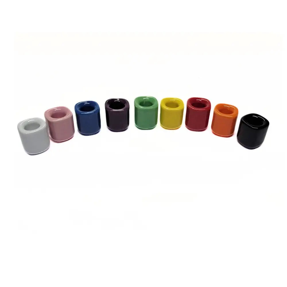 Colorful ceramic taper candle holders on a white background