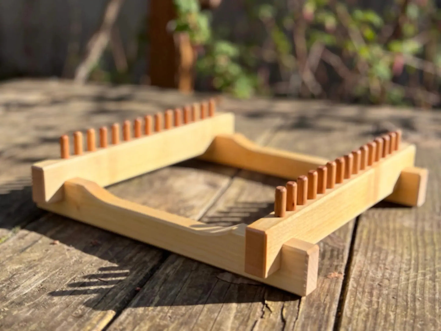 Solid maple wooden potholder loom shown outdoors in natural light