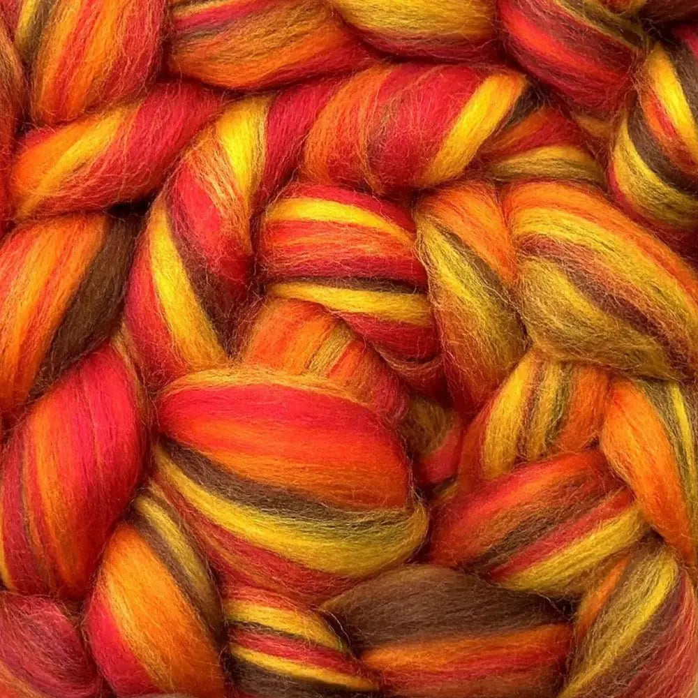 spinning colorful yarn from Merino wool top fiber in oranges and yellow Blaze