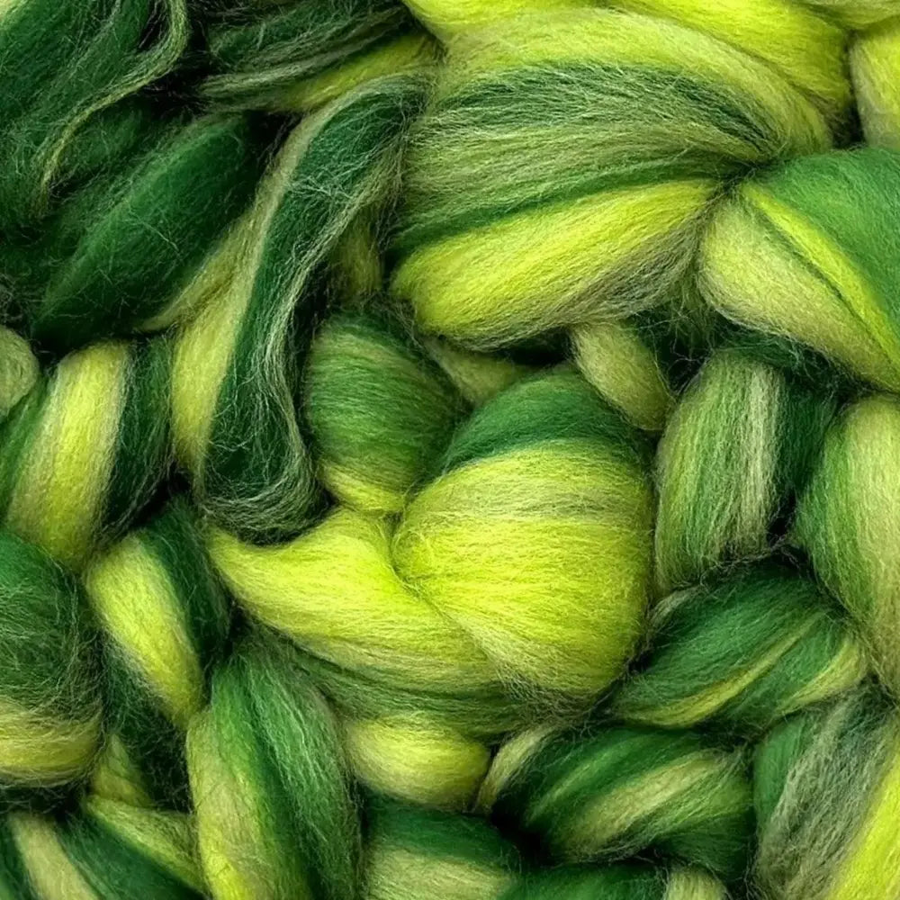 spinning colorful yarn from Merino wool top fiber in yellow-green, green, and dark green