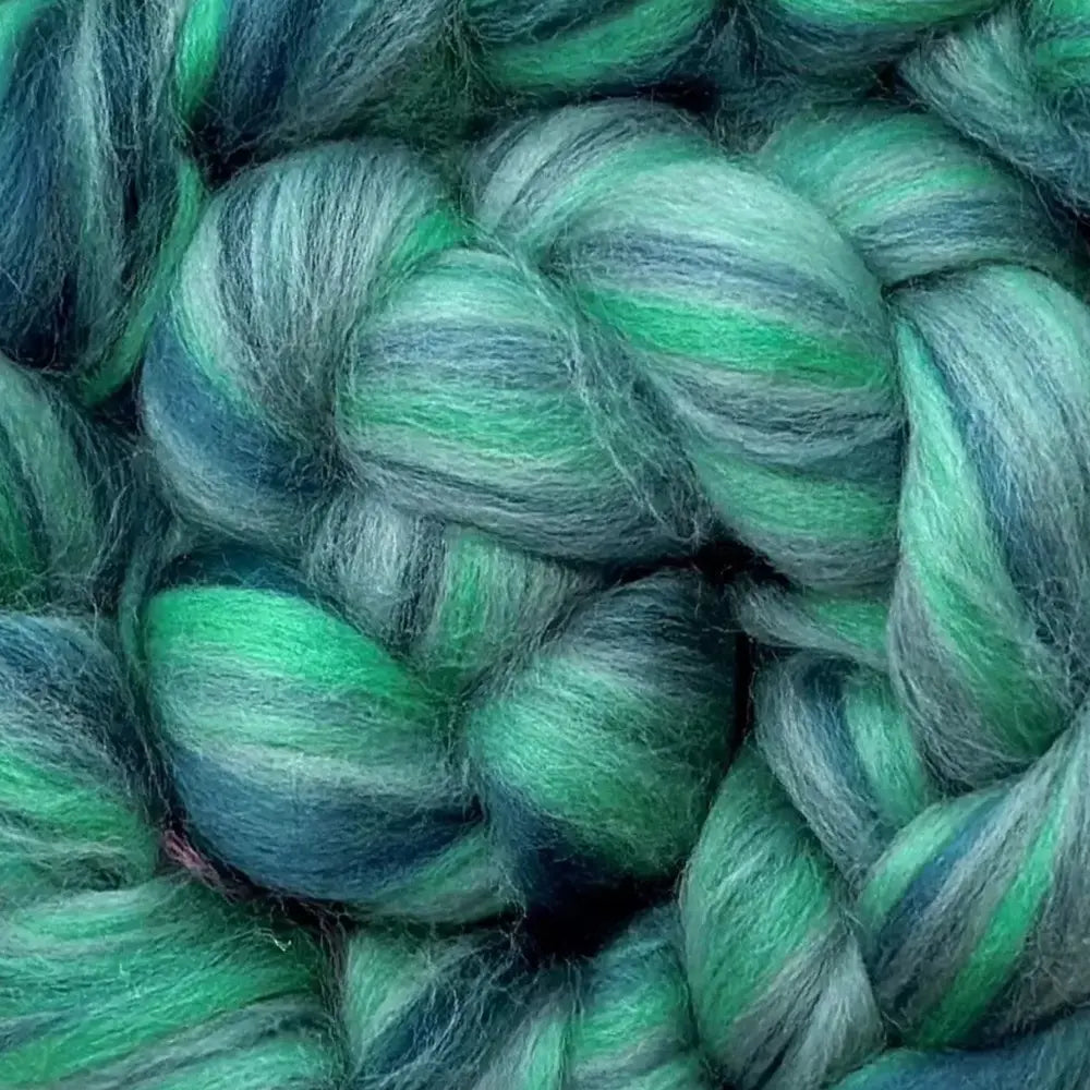 spinning colorful yarn from Merino wool top fiber in aqua, green, and lime