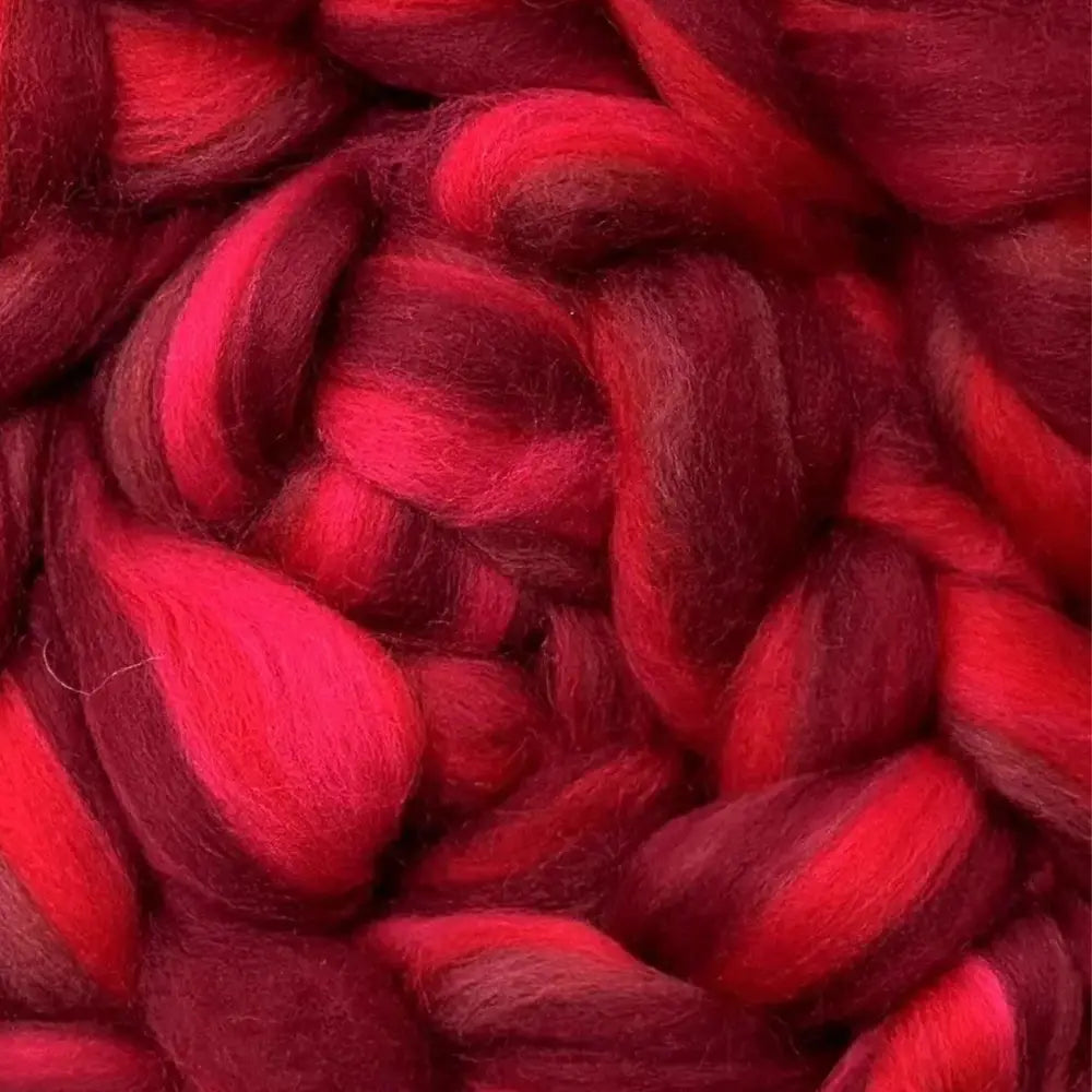 spinning colorful yarn from Merino wool top fiber in Red, Crimson, and Burgundy
