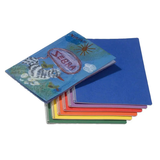 Spiral Waldorf main lesson books stacked in assorted colors with decorated cover example