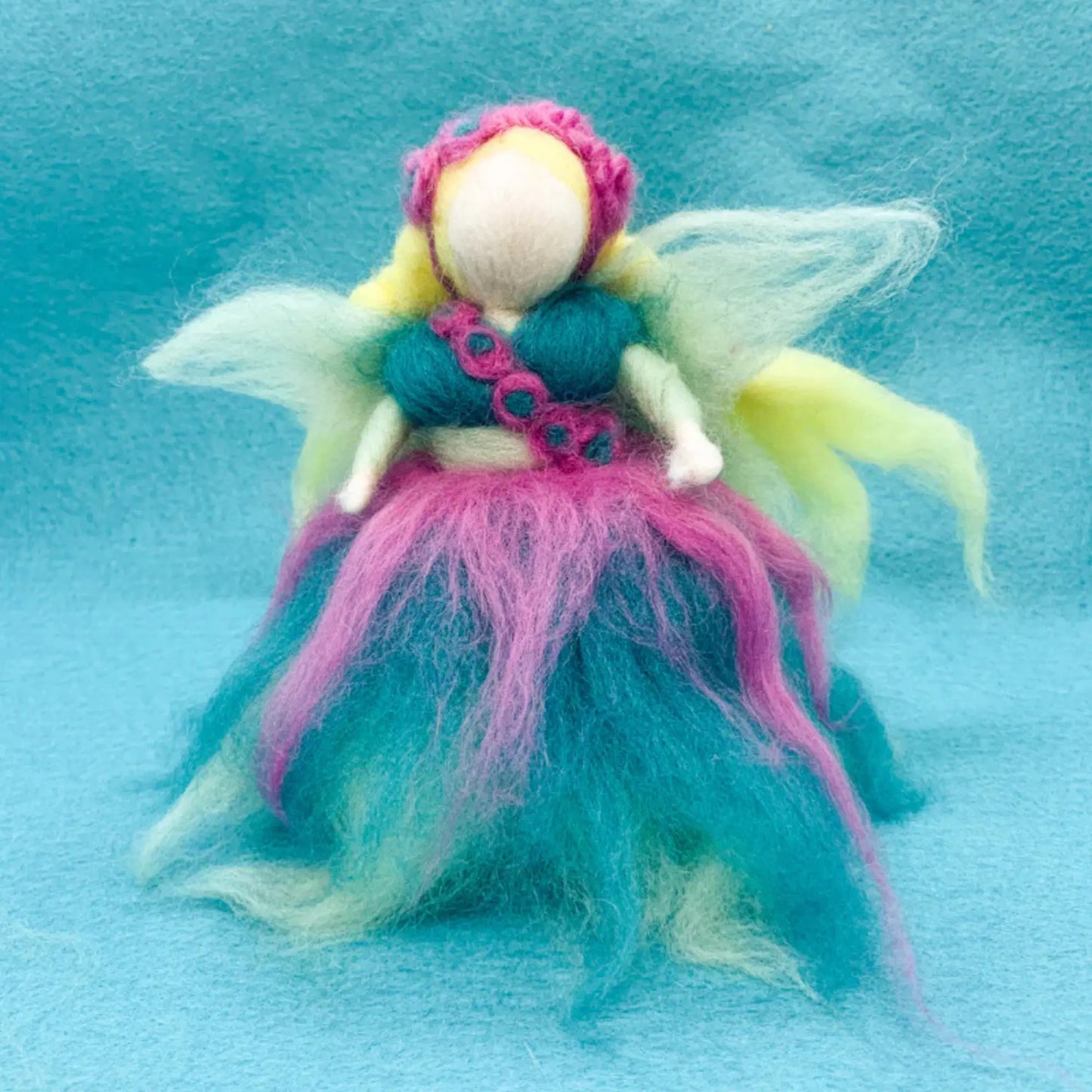 Colorful fairy figurine on a blue background