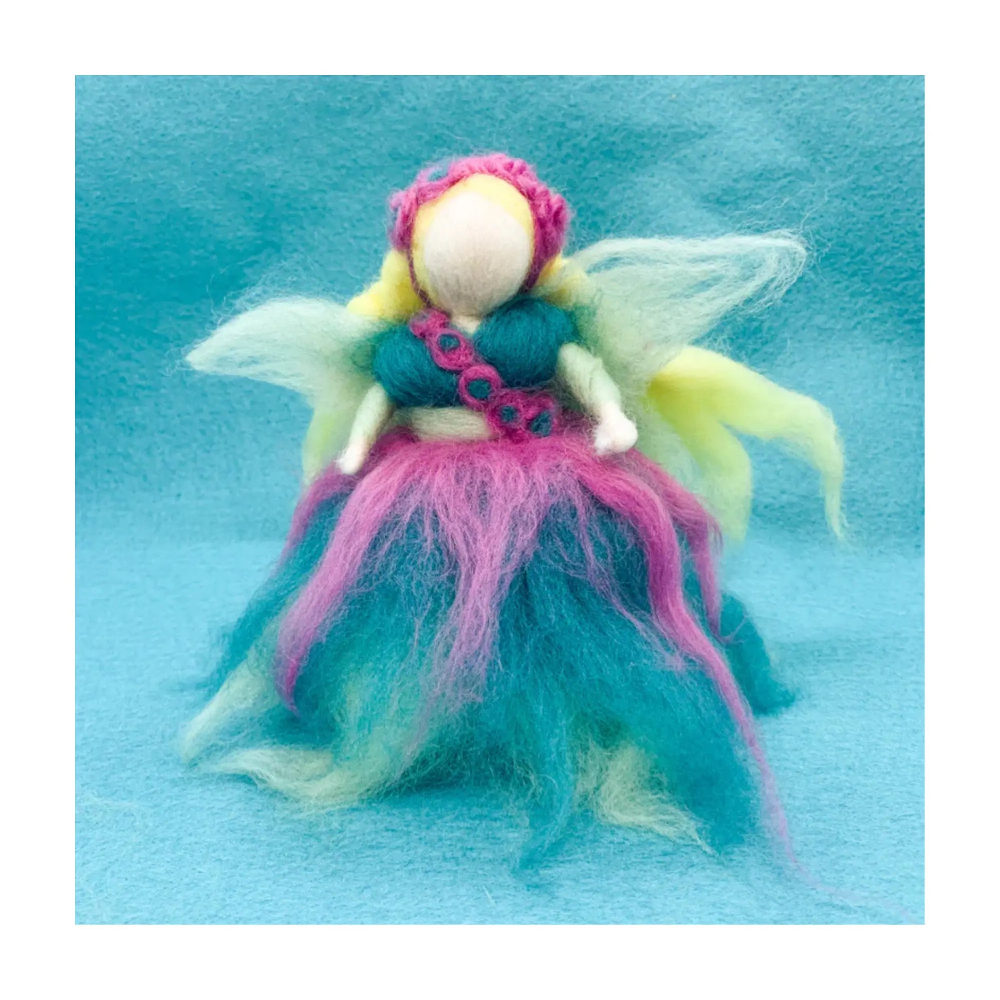 Colorful fairy figurine on a blue background