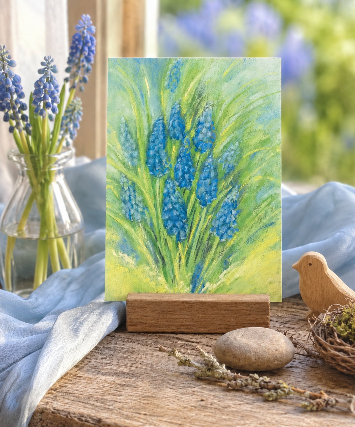 Grape Hyacinth postcard on a rustic table with cloth, flowers, and woooden bird
