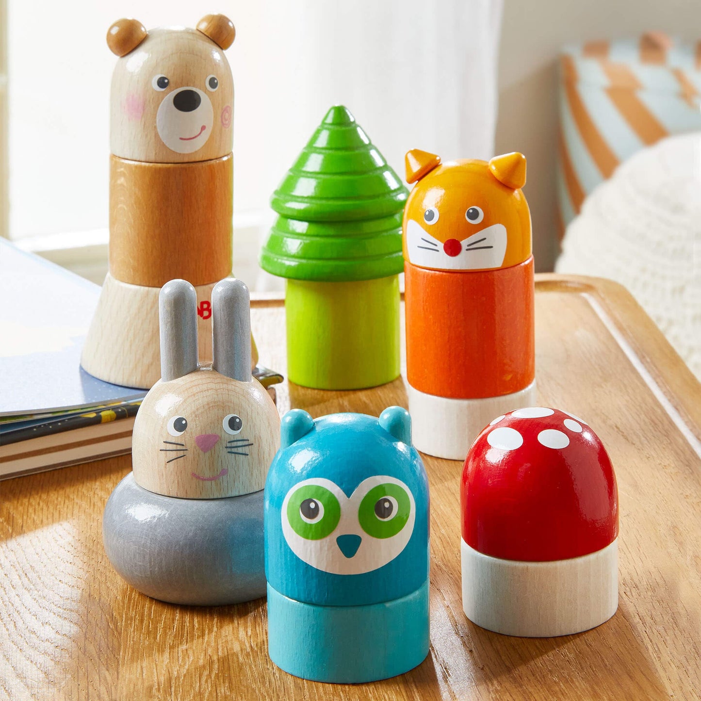 Set of colorful animal-themed wooden toys on a wooden surface
